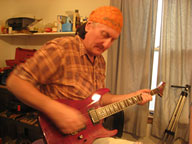 Neil Bartos tuning a guitar